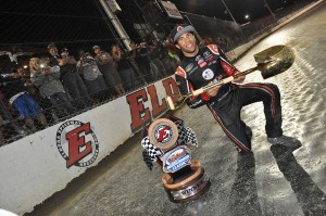 Darrell Wallace Jr poses with the golden shovel and 1-800 CarCash MudSummer Classic trophy