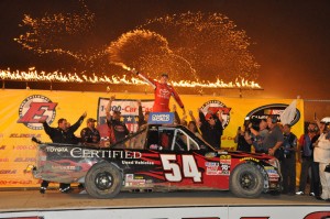 Christopher Bell celebrates after winning the 1-800-Car-Cash Mud Summer Classic