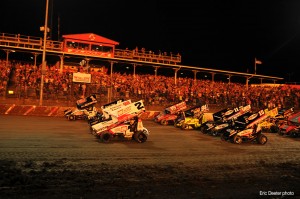 Pyrotechnics light up the backdrop during the World of Outlaws parade lap on Friday evening.