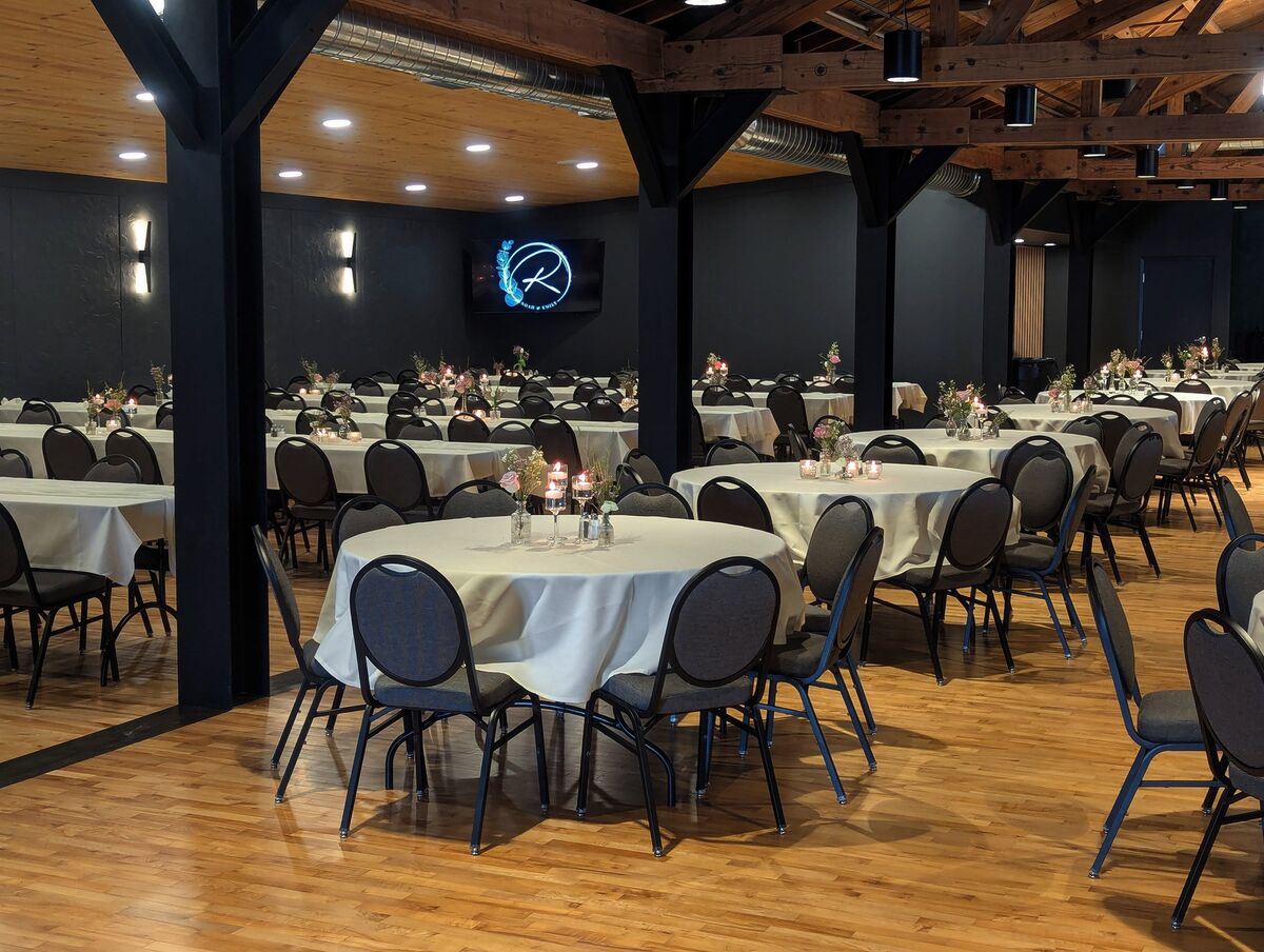 Fall-themed banquet setup inside the Eldora Ballroom with rust and orange floral centerpieces