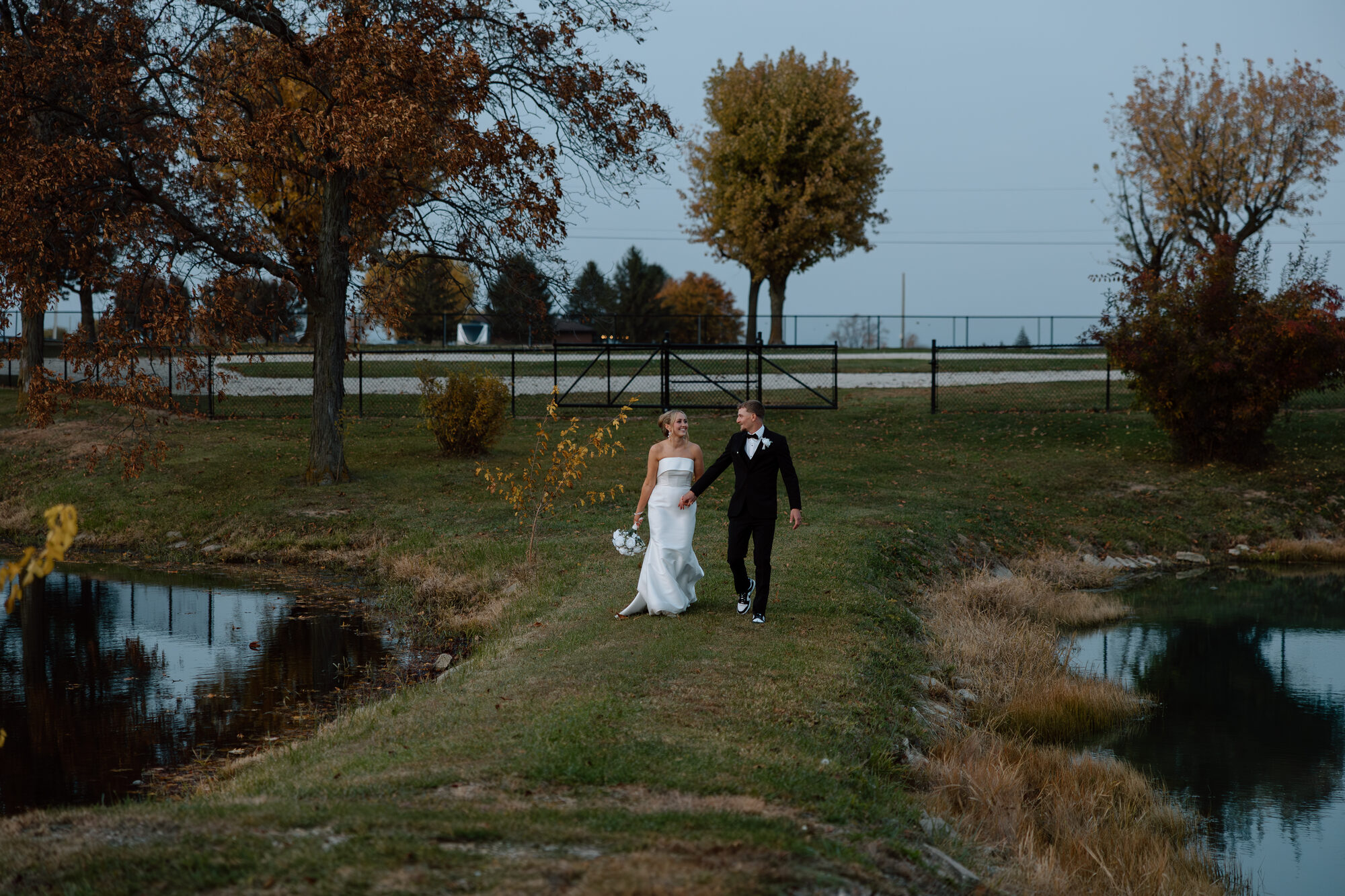 Outdoor wedding ceremony on the Eldora Ballroom patio with guests seated and a floral arch